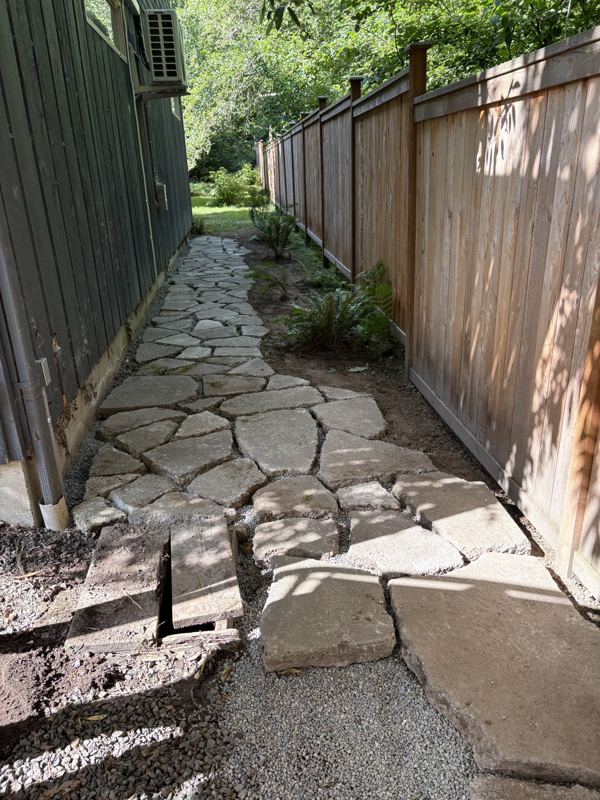 Finished flagstone path along a side yard fence